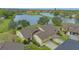 Exterior view of home with two-car garage, and a view of the serene lake at 3119 Glen Elyn Blvd # 9, Sarasota, FL 34237