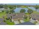 Exterior view of home with two-car garage, lake view, and well-maintained landscaping at 3119 Glen Elyn Blvd # 9, Sarasota, FL 34237