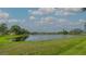 Scenic view of a calm lake surrounded by green lawn and residential buildings at 3119 Glen Elyn Blvd # 9, Sarasota, FL 34237
