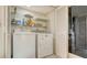 Functional laundry area with side by side washer and dryer and ample storage shelving at 3119 Glen Elyn Blvd # 9, Sarasota, FL 34237