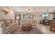 Cozy living space features a large rug, couches, and a view of the dining area at 3119 Glen Elyn Blvd # 9, Sarasota, FL 34237
