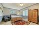 Main bedroom featuring a plush bed, armchair, wood wardrobe and neutral walls at 3119 Glen Elyn Blvd # 9, Sarasota, FL 34237