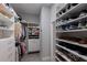 Custom walk-in closet with ample shelving and organization systems for clothes and shoes at 3605 Wild Blossom Pl, Parrish, FL 34219