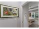 Hallway leading to bedroom, featuring artwork and neutral color scheme at 3605 Wild Blossom Pl, Parrish, FL 34219