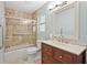 Bathroom featuring a tile shower/bathtub combination and a wood vanity with marble countertop at 3672 Pine Rd, Venice, FL 34293