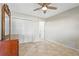 Neutral bedroom with a ceiling fan, closet, and tile flooring at 3672 Pine Rd, Venice, FL 34293