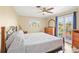 Comfortable bedroom with a decorative bed, dresser, and access to the outdoors at 3672 Pine Rd, Venice, FL 34293