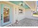 Inviting front entrance with blue door, gray brick, and overhead light fixture at 3672 Pine Rd, Venice, FL 34293