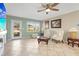Cozy living room featuring plush seating, tile flooring, and ample natural light at 3672 Pine Rd, Venice, FL 34293