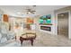 Spacious living room with a decorative fireplace, tile floors, and an open floor plan at 3672 Pine Rd, Venice, FL 34293