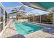 Sparkling pool enclosed by a screened lanai, creating a private and refreshing backyard oasis at 3672 Pine Rd, Venice, FL 34293