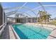 The pool has a screened enclosure, set within a lush green backyard oasis at 3672 Pine Rd, Venice, FL 34293