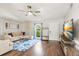 Bright living room featuring a modern ceiling fan, hardwood floors, and contemporary decor at 3907 5Th W Ave, Palmetto, FL 34221