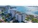 Aerial view of a luxury high-rise condominium with beautiful ocean views and mature landscaping at 435 S Gulfstream Ave # 804, Sarasota, FL 34236