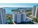 An aerial shot displays a white luxury condominium with a pool, garage, and stunning waterfront views at 435 S Gulfstream Ave # 804, Sarasota, FL 34236