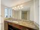 Bathroom features a large mirror, marble countertops, and updated lighting at 435 S Gulfstream Ave # 804, Sarasota, FL 34236