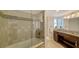 Bright bathroom includes a walk-in shower with a glass door and a marble-top vanity at 435 S Gulfstream Ave # 804, Sarasota, FL 34236