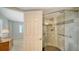 Bathroom featuring an accessible shower with stone flooring and glass door at 435 S Gulfstream Ave # 804, Sarasota, FL 34236