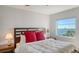 Well-lit bedroom boasts a serene water view from the window and warm, inviting decor at 435 S Gulfstream Ave # 804, Sarasota, FL 34236
