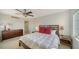 Bright bedroom featuring a ceiling fan, neutral walls, and wood furnishings at 435 S Gulfstream Ave # 804, Sarasota, FL 34236