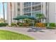 Building entrance featuring a covered entryway surrounded by colorful, tropical landscaping at 435 S Gulfstream Ave # 804, Sarasota, FL 34236