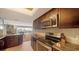 Gourmet kitchen featuring modern appliances and a stylish backsplash, open to the living area with city views at 435 S Gulfstream Ave # 804, Sarasota, FL 34236