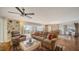 Spacious living room with hardwood floors, ceiling fan, comfortable seating, and balcony access showcasing city views at 435 S Gulfstream Ave # 804, Sarasota, FL 34236