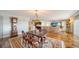 Open-concept living room with a large dining table, hardwood floors, a recliner sofa, and a view of the kitchen at 435 S Gulfstream Ave # 804, Sarasota, FL 34236