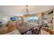 Spacious living room featuring hardwood floors, an elegant dining table, built-in shelves, and a stunning chandelier at 435 S Gulfstream Ave # 804, Sarasota, FL 34236