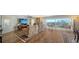Bright living room featuring wood floors, a recliner sofa, large screen TV, and a view of the city skyline at 435 S Gulfstream Ave # 804, Sarasota, FL 34236