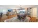 Spacious living room featuring hardwood floors, an elegant dining table, built-in shelves, and city views at 435 S Gulfstream Ave # 804, Sarasota, FL 34236