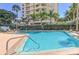 Outdoor pool area with lush landscaping and a view of the building at 435 S Gulfstream Ave # 804, Sarasota, FL 34236