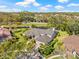 Expansive estate with lush landscaping, mature trees, and a serene pond view at 4477 White Cedar Trl, Sarasota, FL 34238