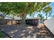 Shaded backyard featuring a large tree and a screened in porch, and surrounded by a fence at 470 Leach St, Englewood, FL 34223