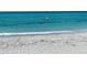 Picturesque beach scene with clear ocean water and distant paddle boarder, ideal for relaxation at 470 Leach St, Englewood, FL 34223