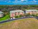 A high angle shows the multi-story condos, nearby parking, and well-kept lawn at 5246 Manorwood Dr # 4, Sarasota, FL 34235