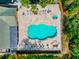 A high angle of a kidney shaped pool with lounge chairs and palm trees at 5246 Manorwood Dr # 4, Sarasota, FL 34235