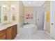 Bathroom with double vanity, soaking tub, and glass shower at 5246 Manorwood Dr # 4, Sarasota, FL 34235