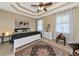 Bedroom with tray ceiling, ceiling fan, and carpeted floor at 5246 Manorwood Dr # 4, Sarasota, FL 34235