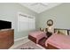Cozy bedroom featuring two twin beds, soft green walls, and a large window at 5246 Manorwood Dr # 4, Sarasota, FL 34235