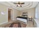 Bedroom with tray ceiling, ceiling fan, and carpeted floor at 5246 Manorwood Dr # 4, Sarasota, FL 34235