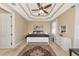 Bedroom with tray ceiling, ceiling fan, and carpeted floor at 5246 Manorwood Dr # 4, Sarasota, FL 34235