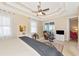 Bedroom with tray ceiling, ceiling fan, carpeted floor, and access to a private balcony at 5246 Manorwood Dr # 4, Sarasota, FL 34235