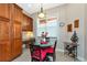 Cozy breakfast nook with a black table, red chair cushions, and plenty of natural light at 5246 Manorwood Dr # 4, Sarasota, FL 34235