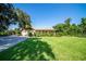 Charming single-story home boasts a lush green lawn and well-maintained landscaping at 5246 Manorwood Dr # 4, Sarasota, FL 34235