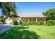 Charming single-story home boasts a lush green lawn and well-maintained landscaping at 5246 Manorwood Dr # 4, Sarasota, FL 34235