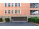 Exterior view of the condo garage door and pedestrian door with exterior lighting at 5246 Manorwood Dr # 4, Sarasota, FL 34235