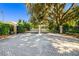 Private gated entrance with brick paved driveway, mature landscaping, and security features at 5246 Manorwood Dr # 4, Sarasota, FL 34235