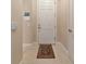 Hallway view showing front door with a warm rug and white walls at 5246 Manorwood Dr # 4, Sarasota, FL 34235