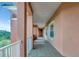 Exterior hallway featuring peachy colored stucco walls and gray tiled floor at 5246 Manorwood Dr # 4, Sarasota, FL 34235